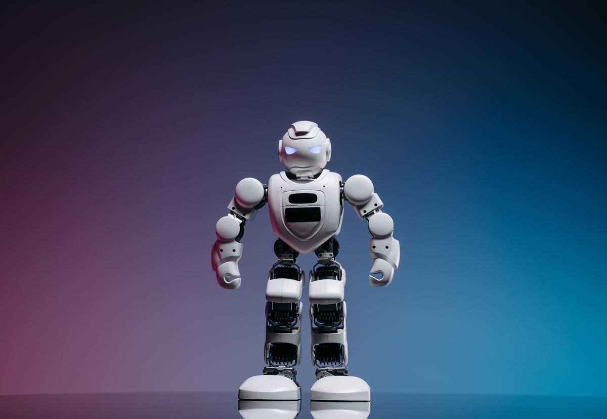 Small robot on a blue and purple background representing practical AI strategy