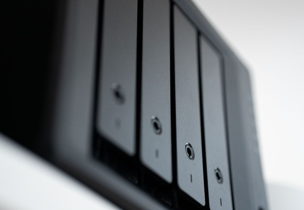 Close up of several black storage drive bays representing the backup copies that support business recovery