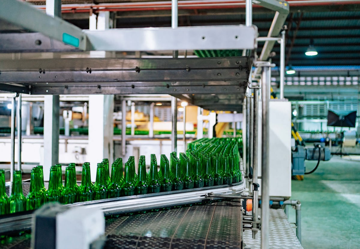 Factory production line representing delivery flow, bottlenecks and scaling pressure