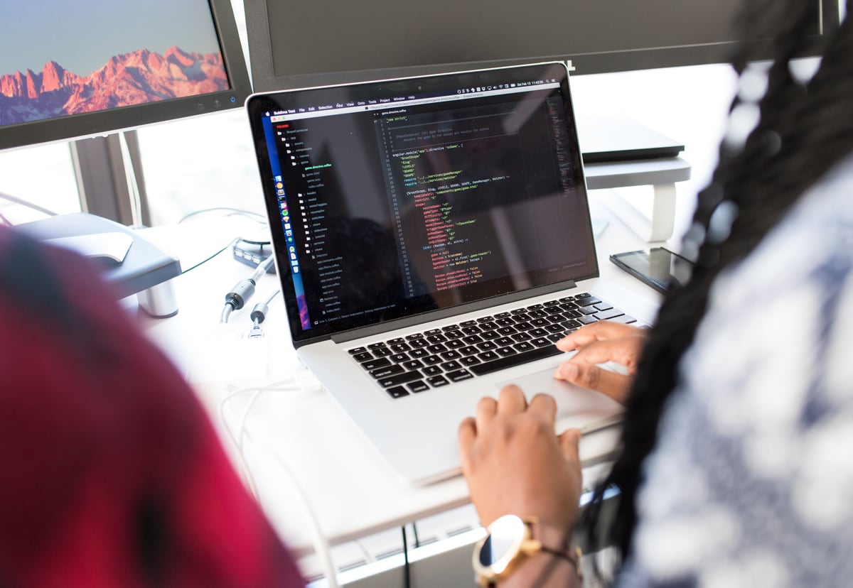 Developer working at a laptop representing engineering leadership and team direction